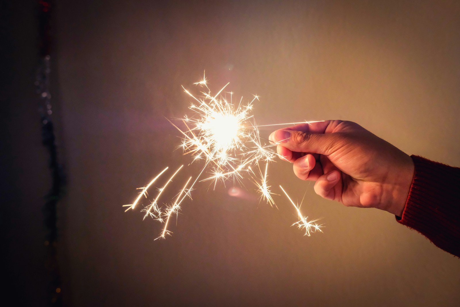 a person holding a sparkler in their hand