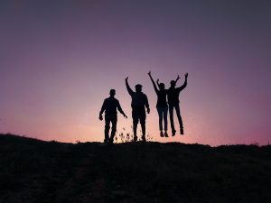 a group of people standing on top of a hill